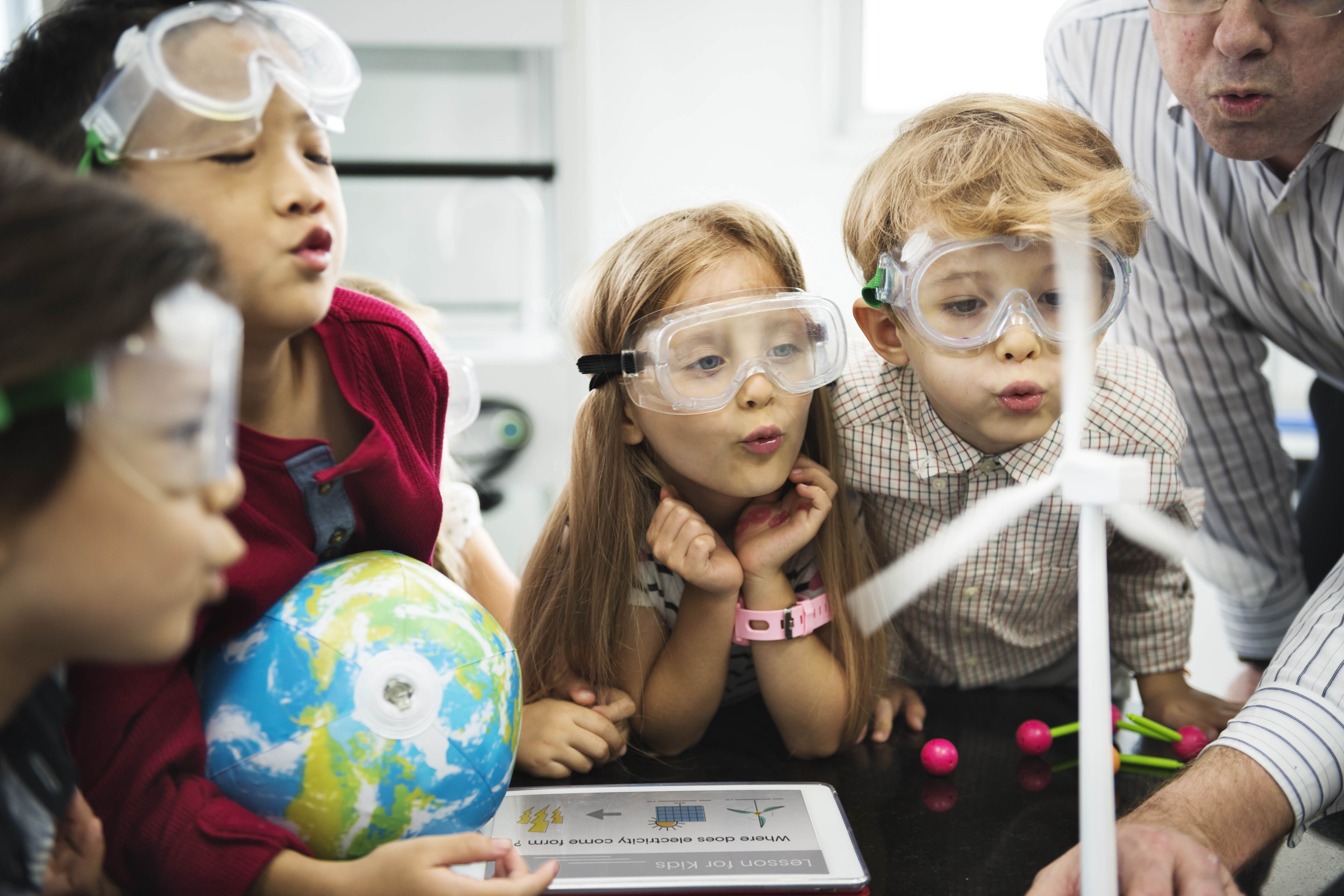 children in science lab wearing goggles
