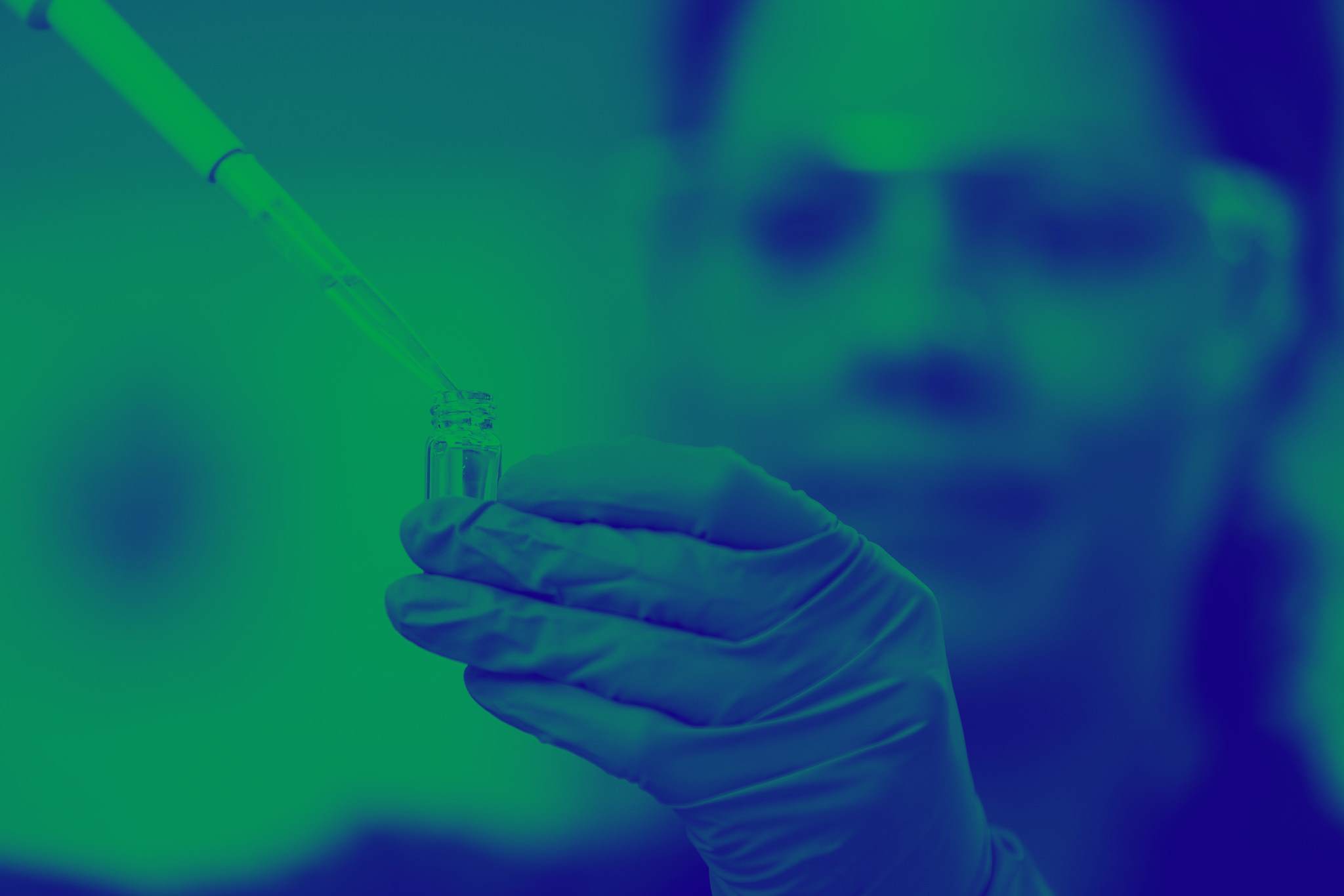 Green washed image of liquid being pippeted