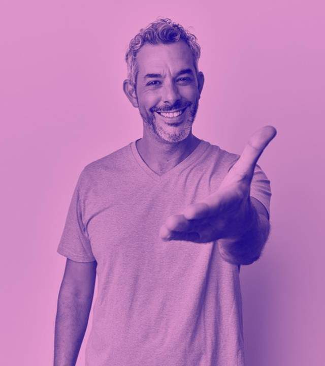 image of man smiling, holding out his arm