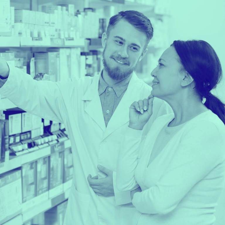 pharmacist and consumer looking at offering in a pharmacy