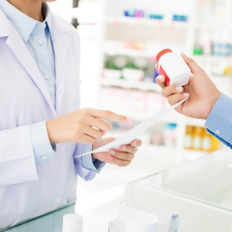 medicine being handed over the counter