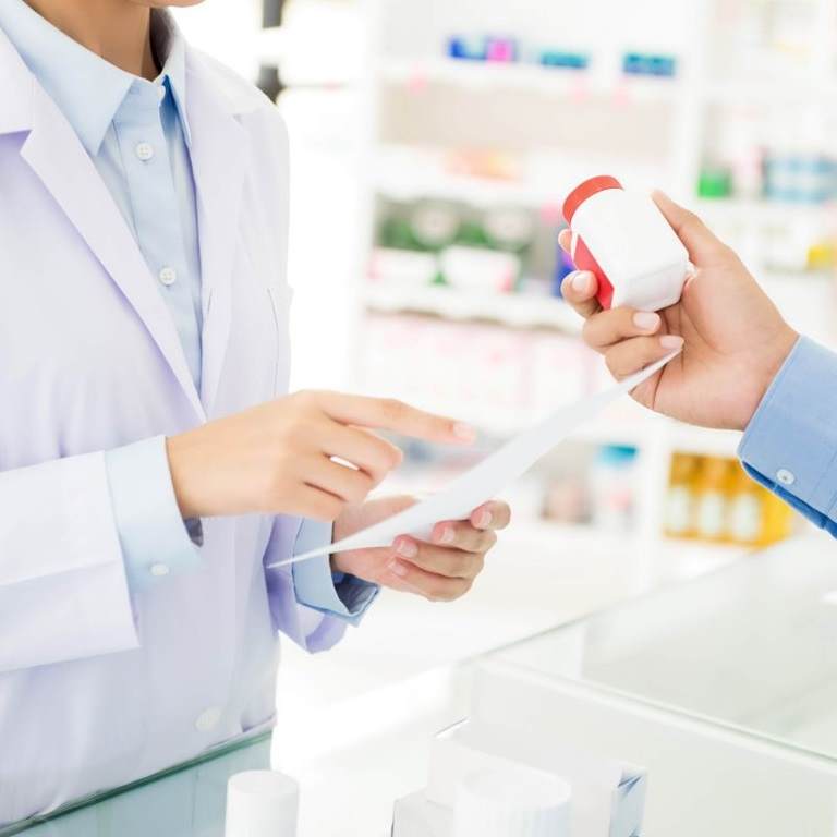 pharmacist and customer in pharmacy with over the counter medicine