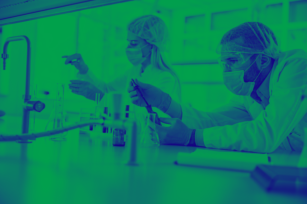 Blue and green washed image of two people in lab