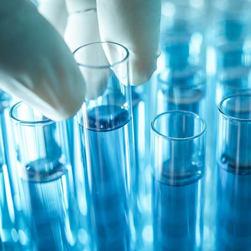 test tubes in a row with glove in shot lifting one of them
