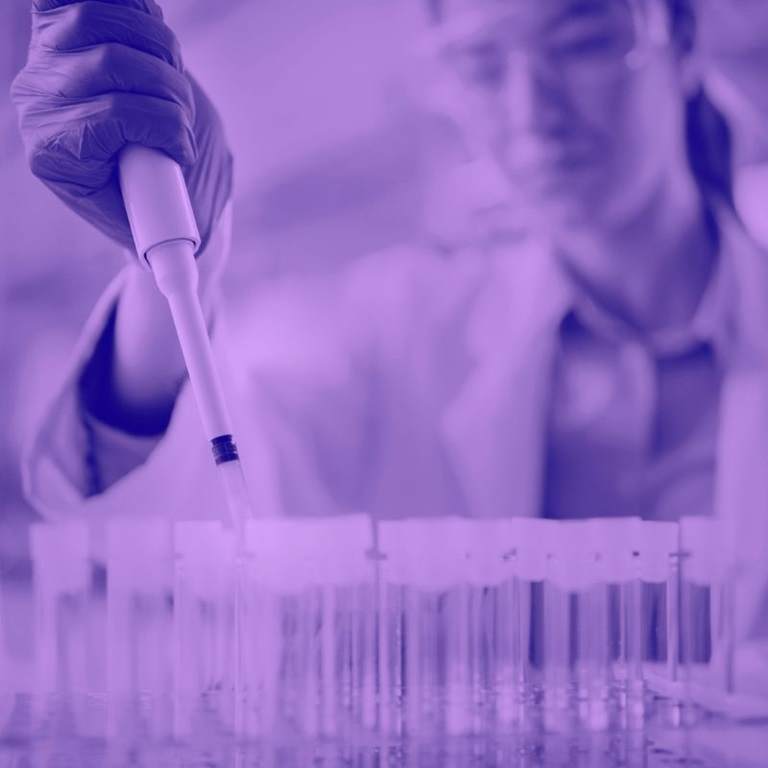 Purple washed image of female scientist in lab using a pipette 