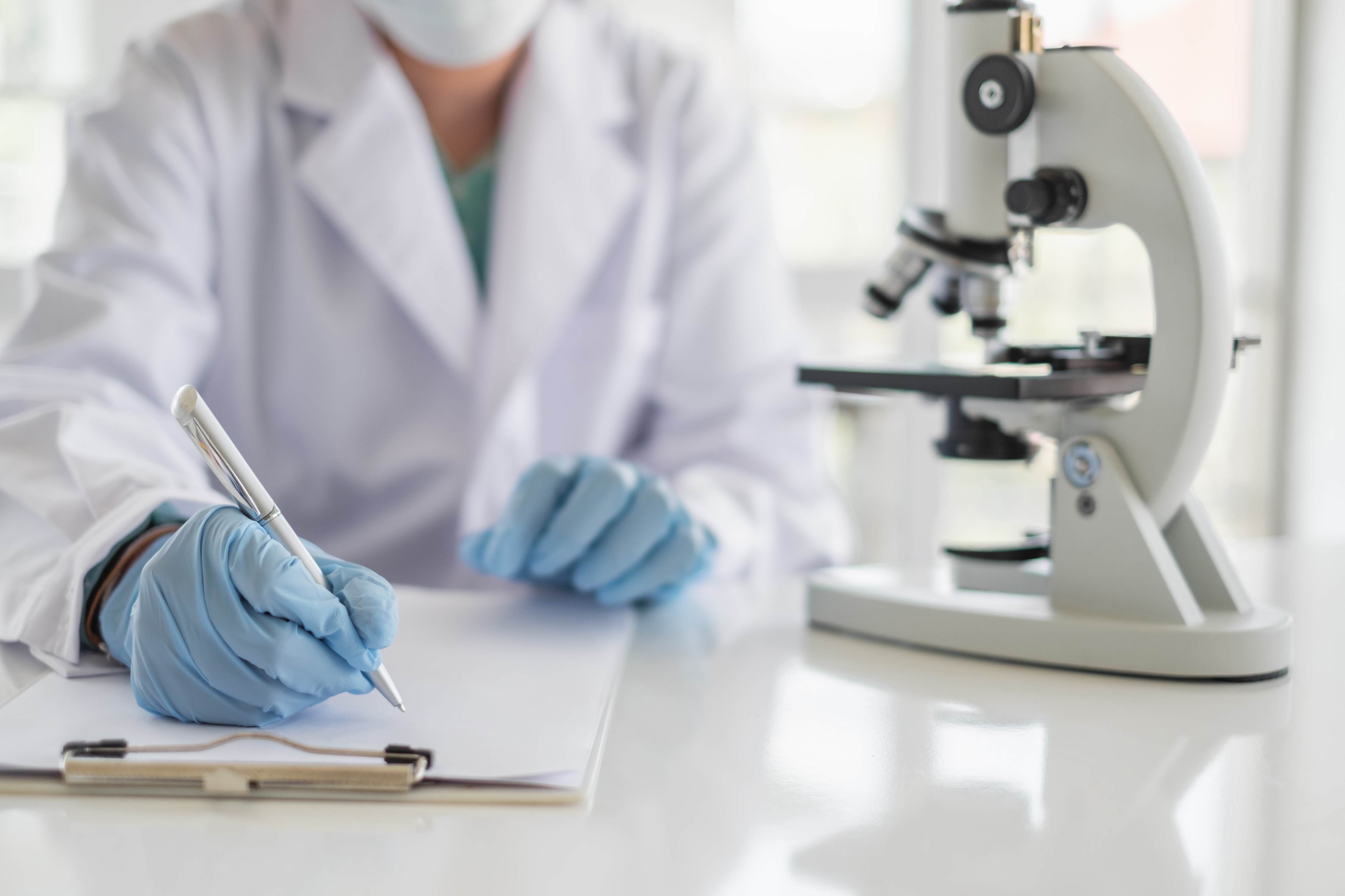 Image of hand and lab coat in lab