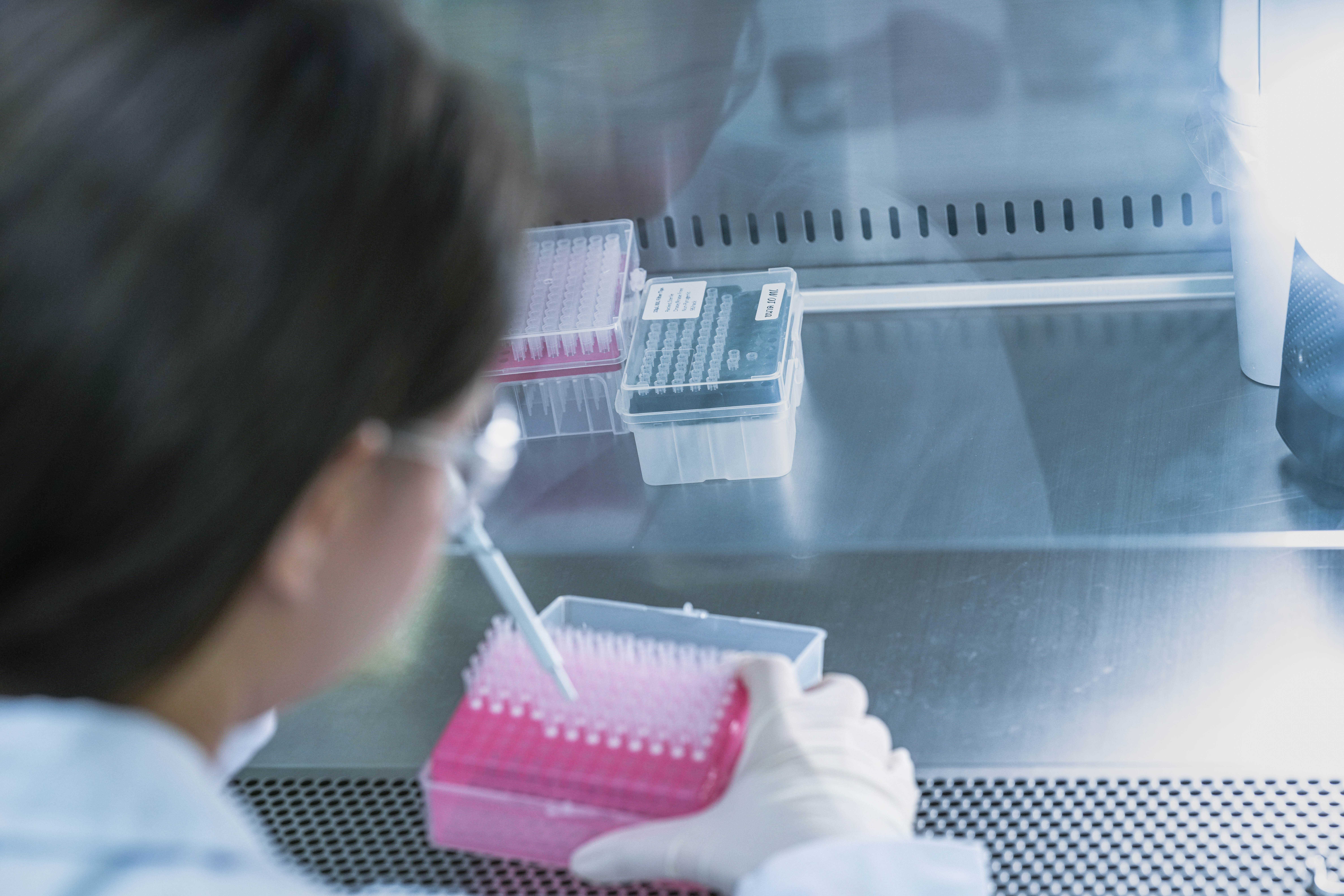 Female in lab with a try