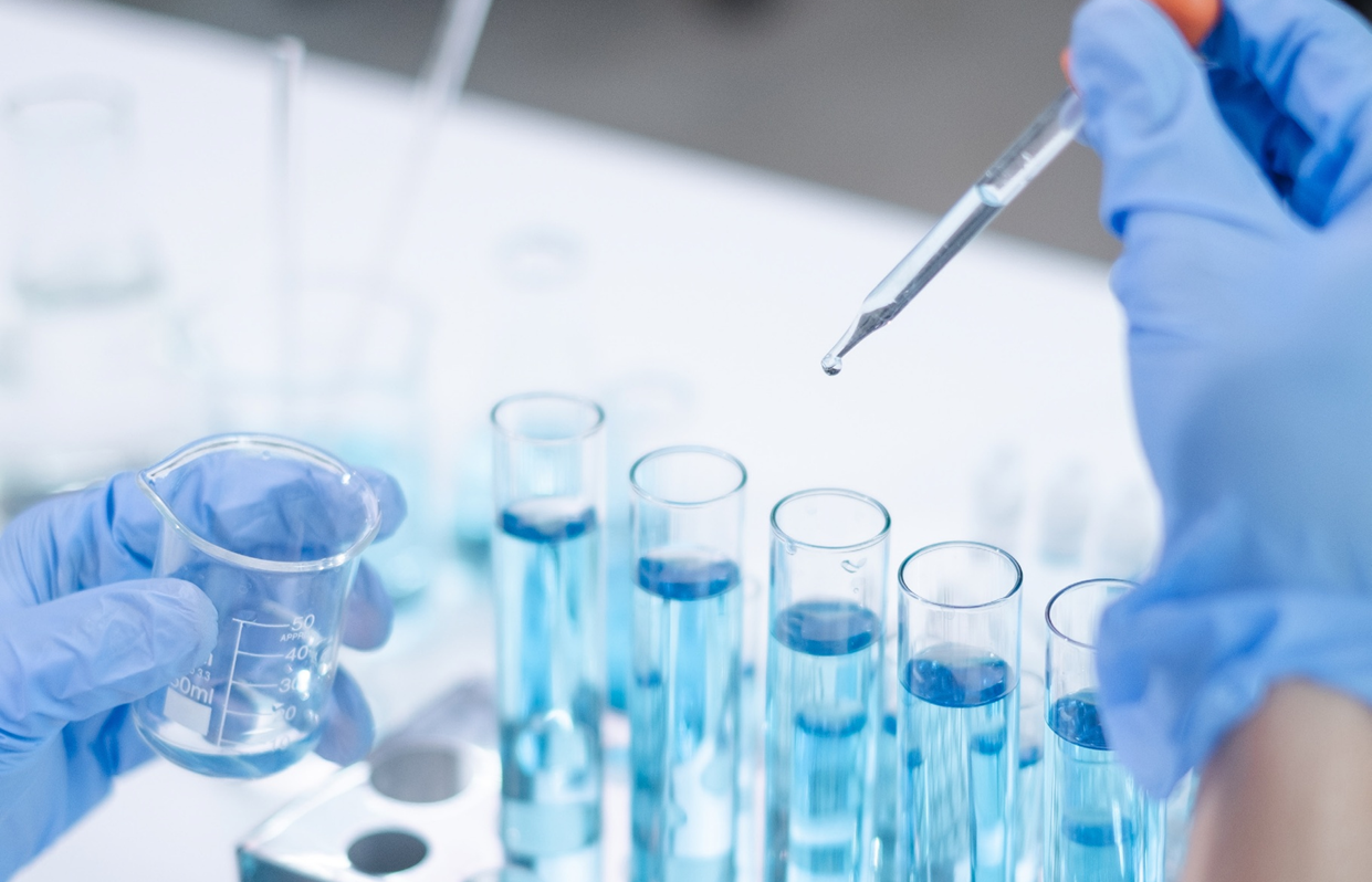 Image of test tubes with hand and pipette