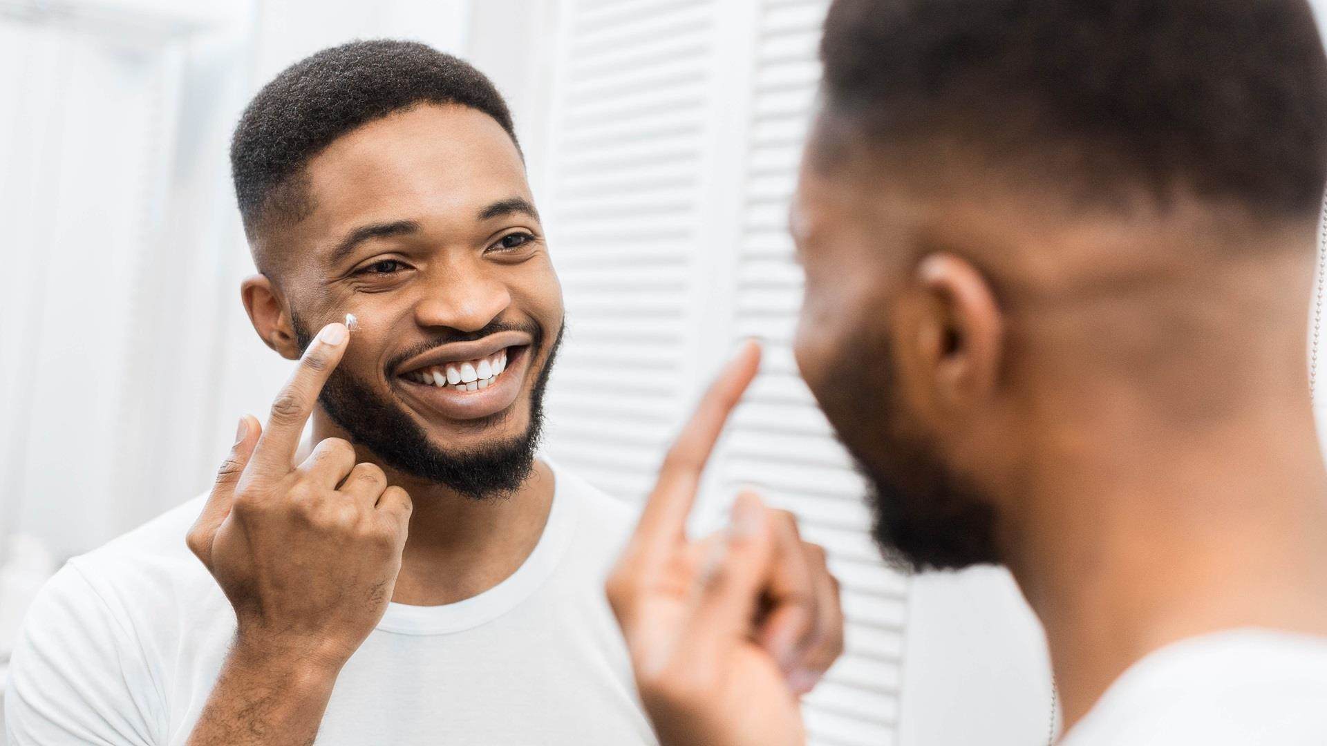 Man applying cream on his face